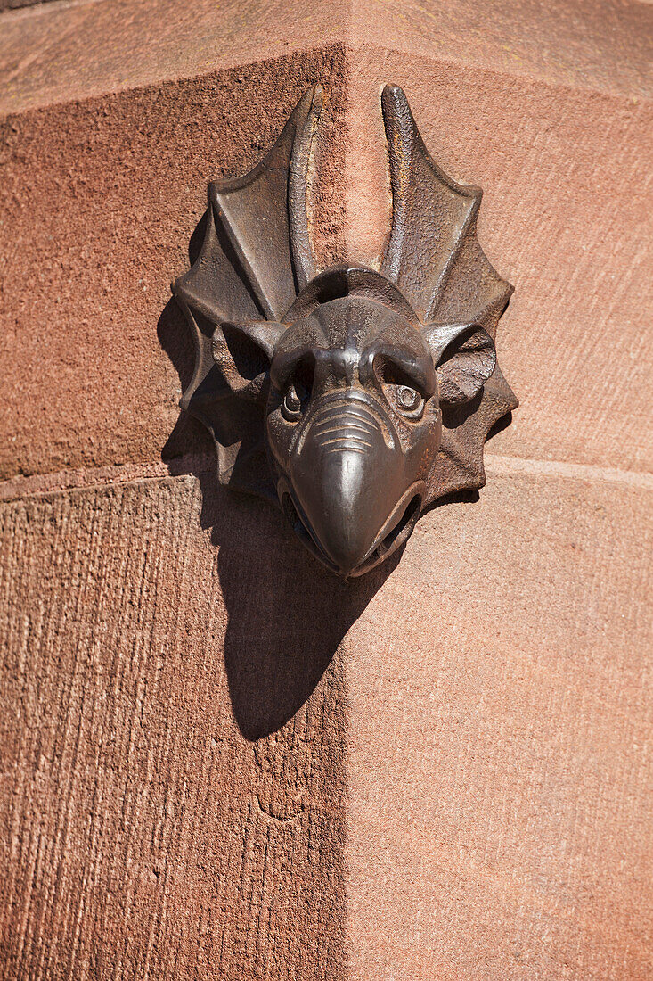 'A Sandstone Beaked Gargoyle Face On A Building's Corner; Strasbourg, France'