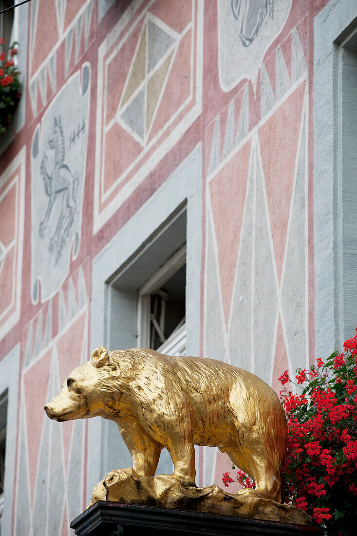 'Gold Bear Sculpture With Flowers And A Painted Building; Freiburg, Germany'