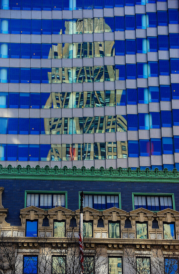 reflection of a building on a blue glass surface. Foot roof of a classical building