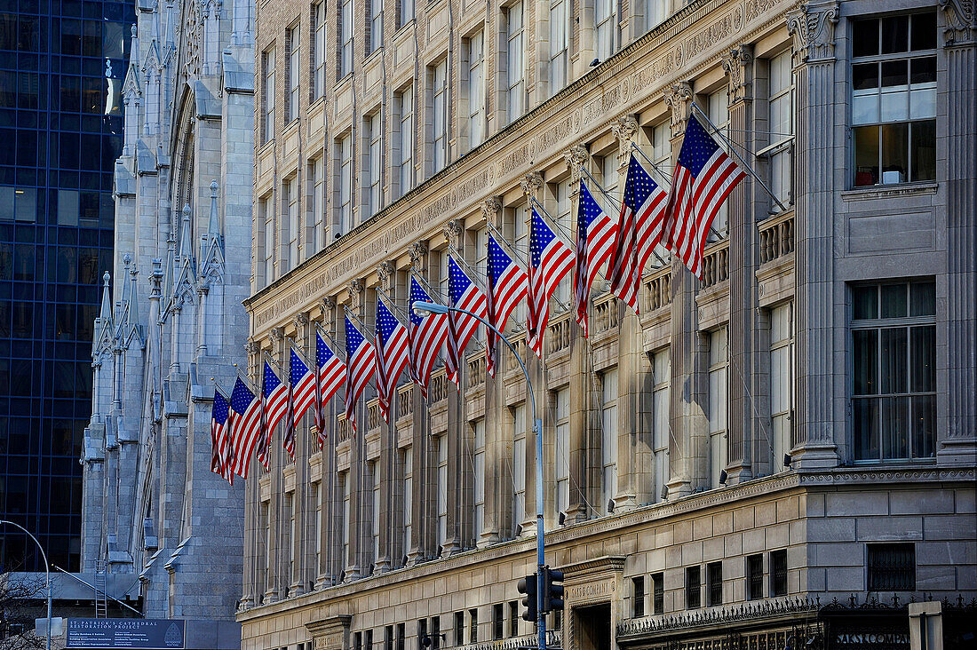 old facade covered with U.S. flag. Cathedral in the background
