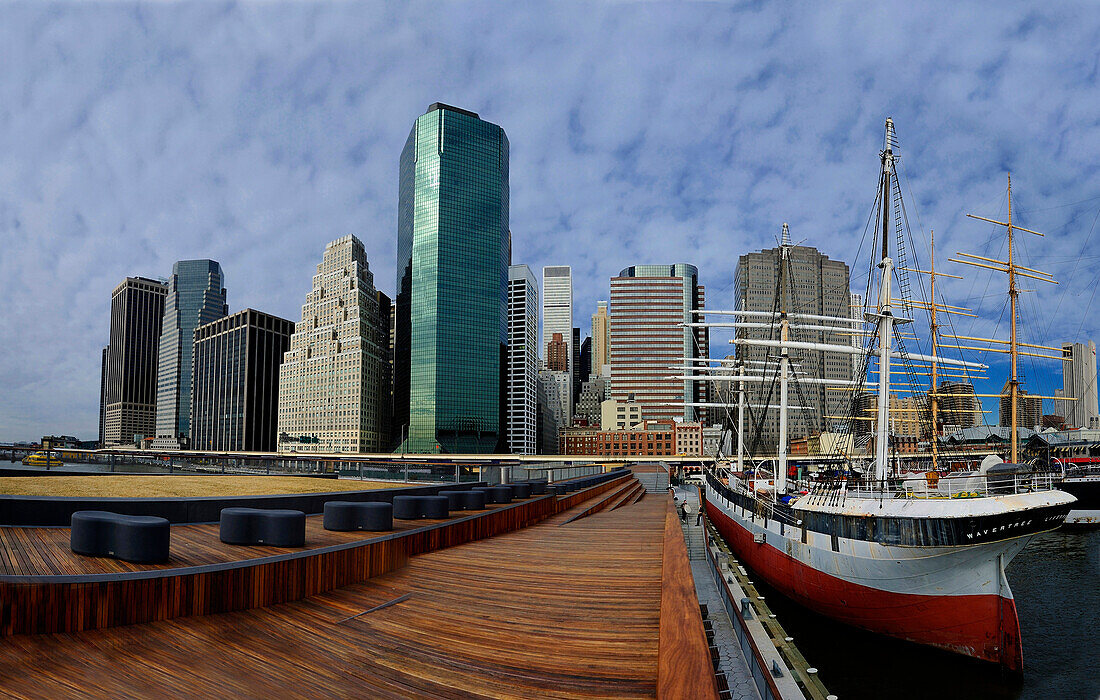 buildings on Wall Street in Manhattan, docks and three moored sailboat masts