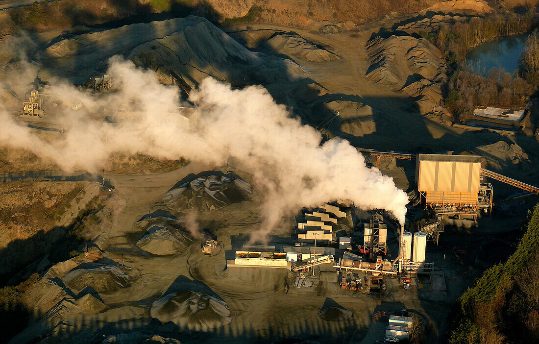 Aerial view of a career. Smoke from a smokestack