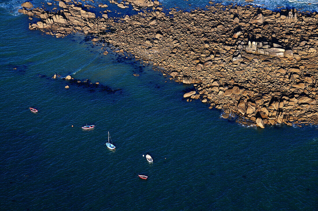 aerial view of several boats moored along a rocky Advanced