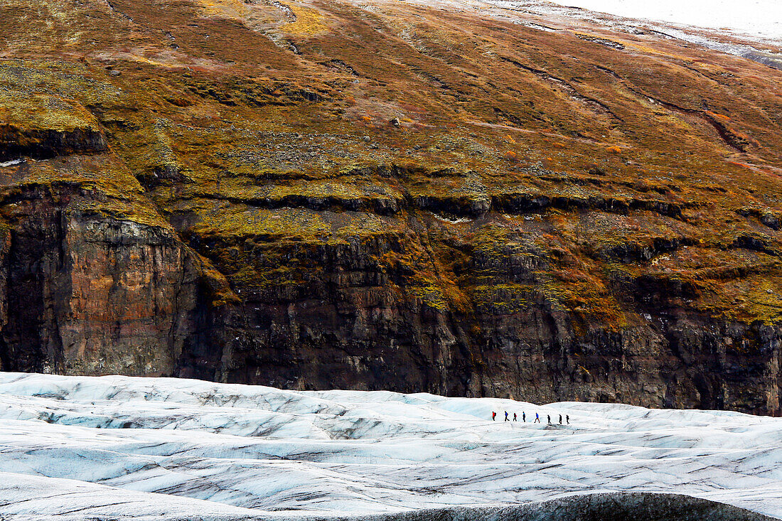 Iceland. Southern region. Glacier Svinafellsjokull. Tourists walking on the glacier.