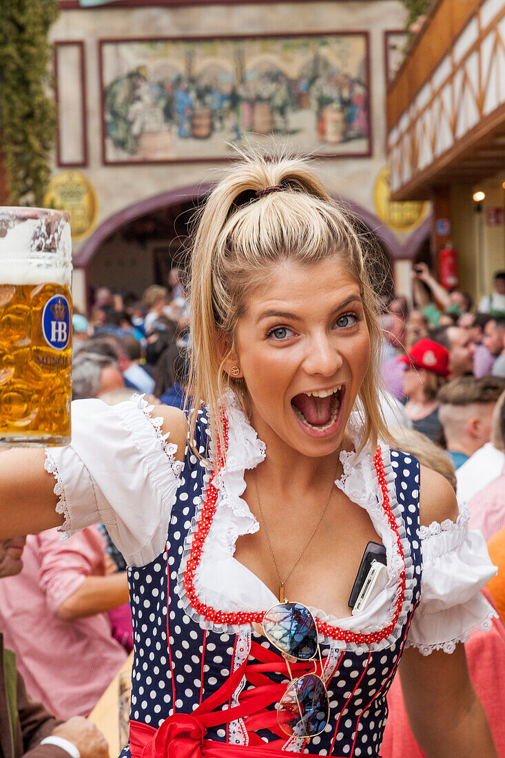 Germany, Baveria, Munich, Oktoberfest, Young Woman Drinking Beer