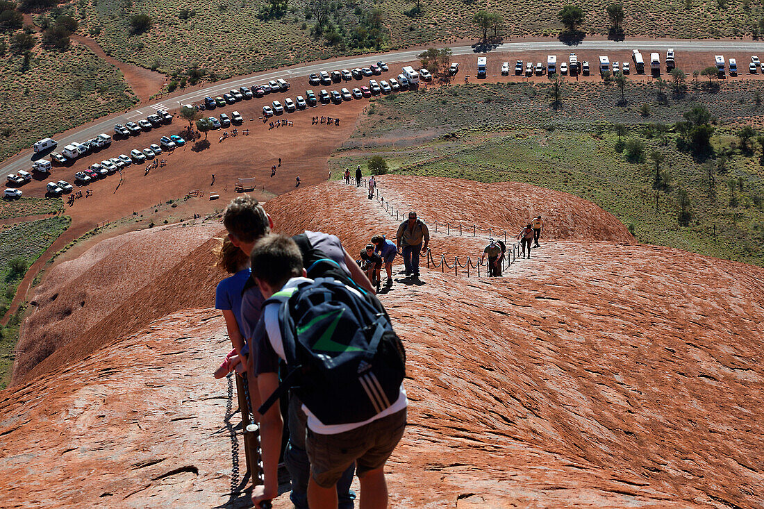 'Tourists walking up Uluru, formerly known as Ayers Rock; Northern Territory, Australia'