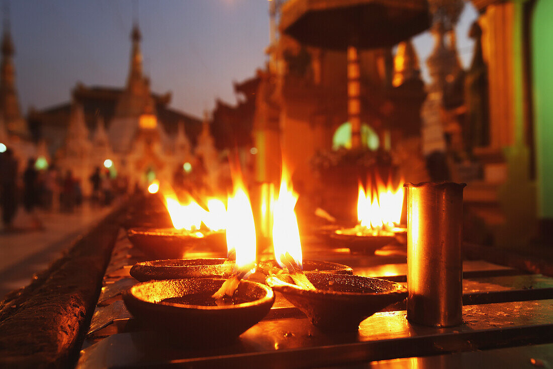 'Oil candles at Shwedagon Pagoda; Yangon, Burma'