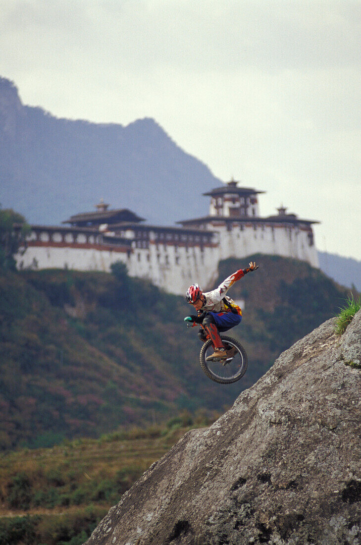 Unicyclist Riding Down Hill