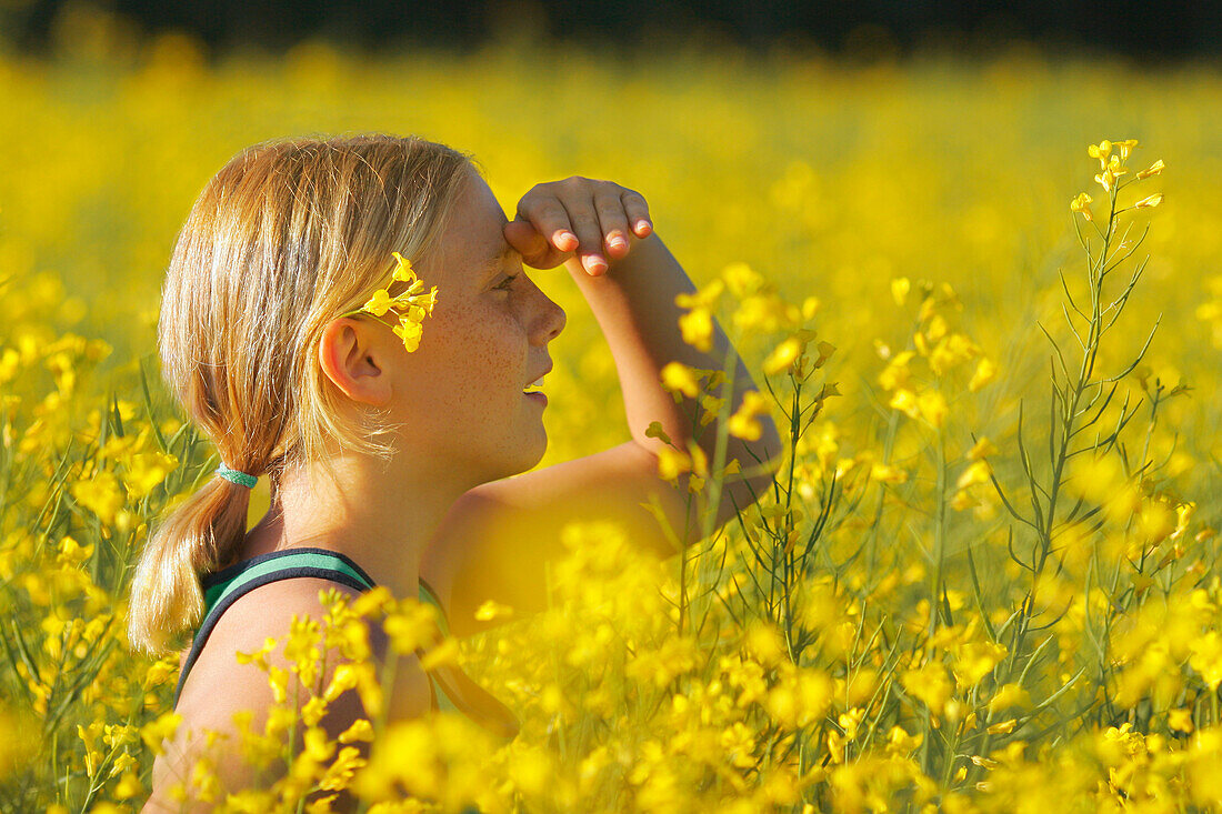 Young Girl In A Field Of Yellow Flowers