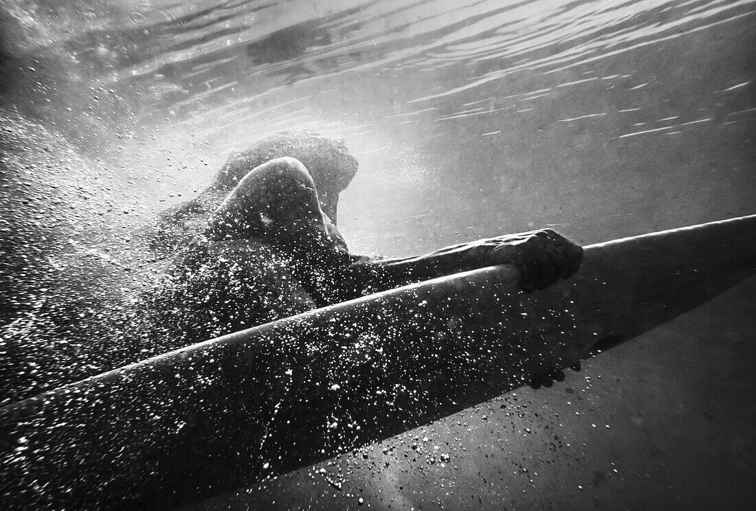 'A Woman On A Surfboard Under The Water; Tarifa, Cadiz, Andalusia, Spain'