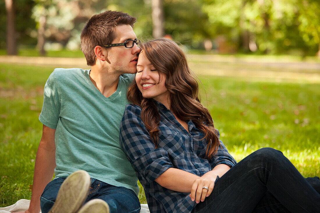 'Newlywed Couple Spending Quality Time Together In A Park; Edmonton, Alberta, Canada'