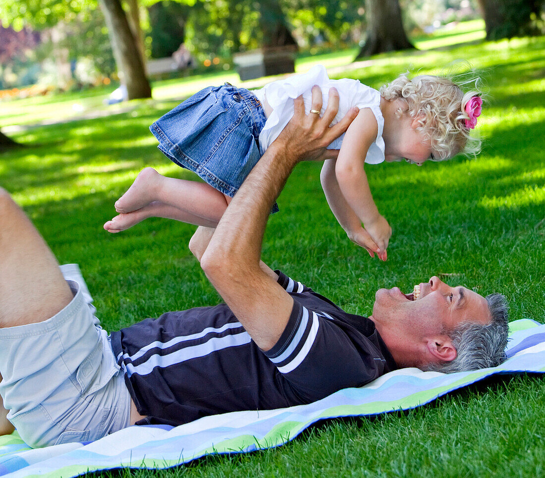 'Father And Young Daughter Spending Quality Time Together In A Park; Edmonton, Alberta, Canada'