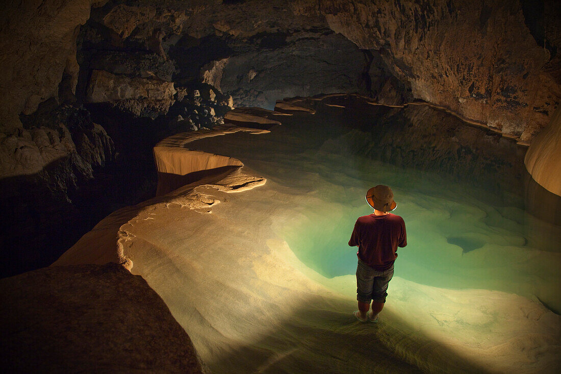 'A Filipino Tour Guide Holds A Lantern Inside Sumaging Cave Or Big Cave; Sagada, Luzon, Philippines'