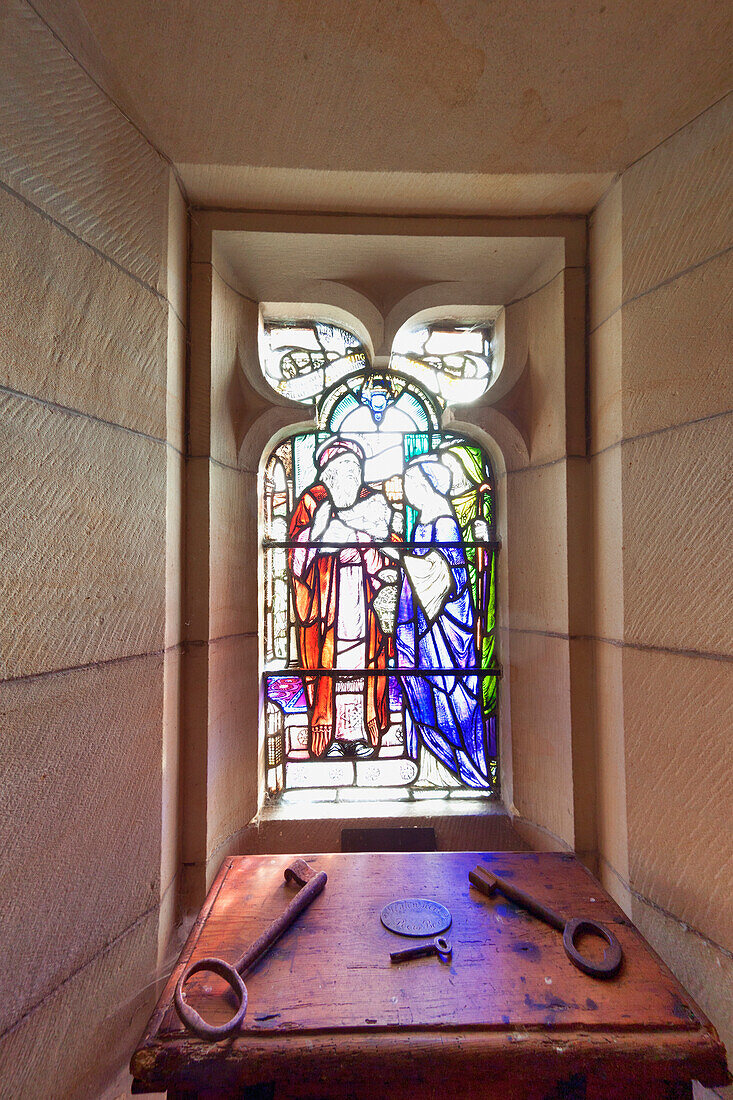 'A Table With Various Sized Keys Laying On It In Front Of A Stained Glass Window; Northumberland, England'