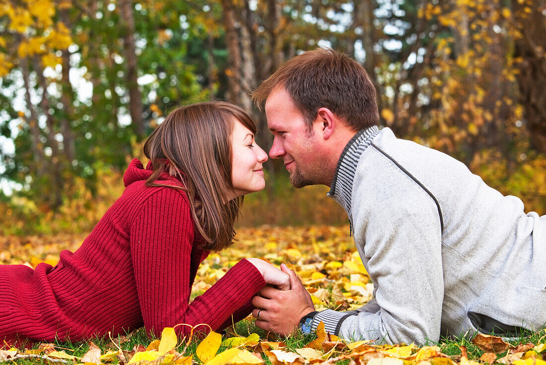 'Young Married Couple Spending Quality Time Together In A Park In Autumn; Edmonton, Alberta, Canada'