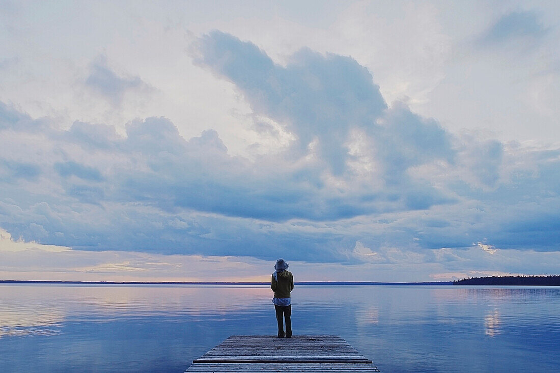 'Woman On Public Dock Clear Lake; Canada, Manitoba, Riding Mountain National Park'