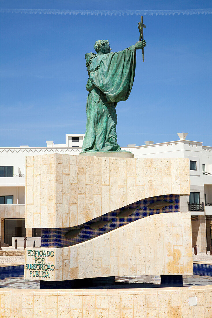 'Green Statue Of A Male Figure Holding A Cross; Lagos Algarve, Portugal'