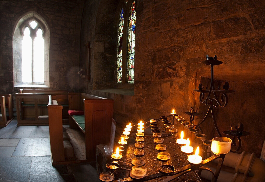 'Candles Lit Inside A Church Sanctuary; Bamburgh, Northumberland, England'