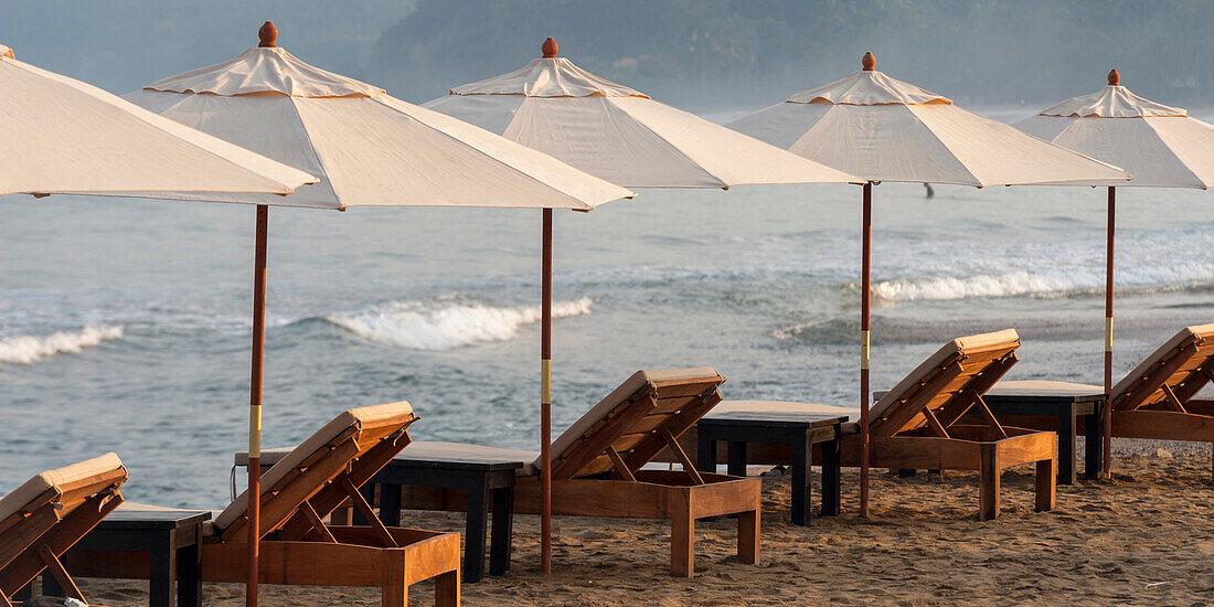 'Beach Chairs And White Umbrellas Lined Up On The Beach Along The Ocean; Sayulita, Mexico'