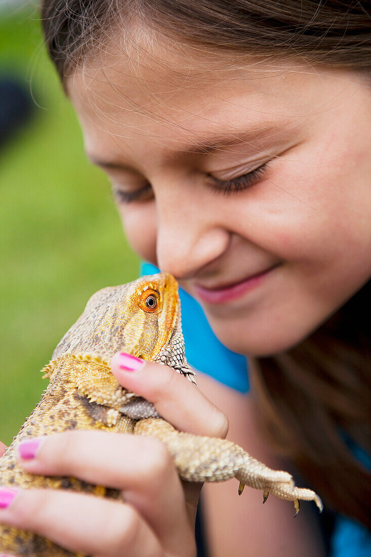 'A Girl Puts A Lizard Up To Her Nose; Edmonton, Alberta, Canada'