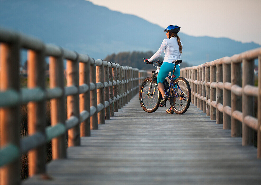 'A Cyclist On A Wooden Boardwalk; Tarifa, Cadiz, Andalusia, Spain'
