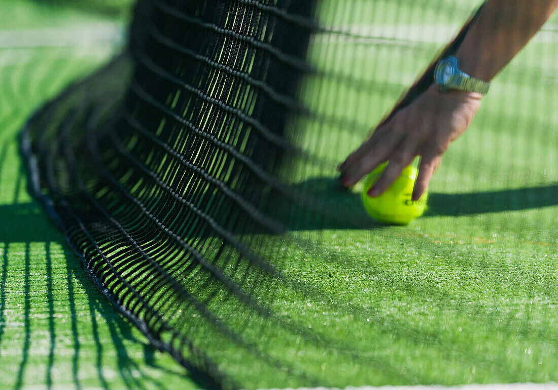 'Retrieving A Tennis Ball By The Net; Tarifa, Cadiz, Andalusia, Spain'