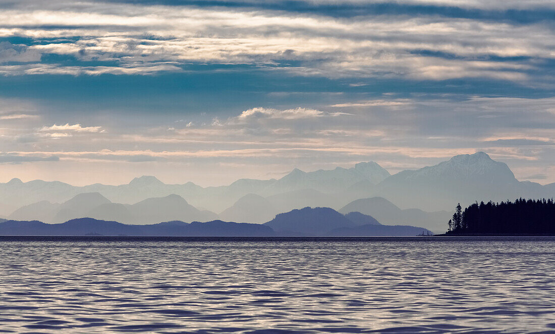 'The Coastal Mountain Range Shrouded In A Morning Mist On The Coast; British Columbia, Canada'