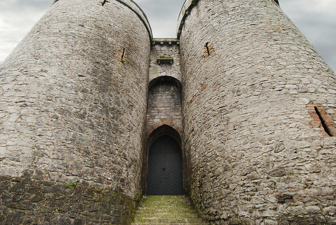 'An arched doorway in between two round towers;Ireland'