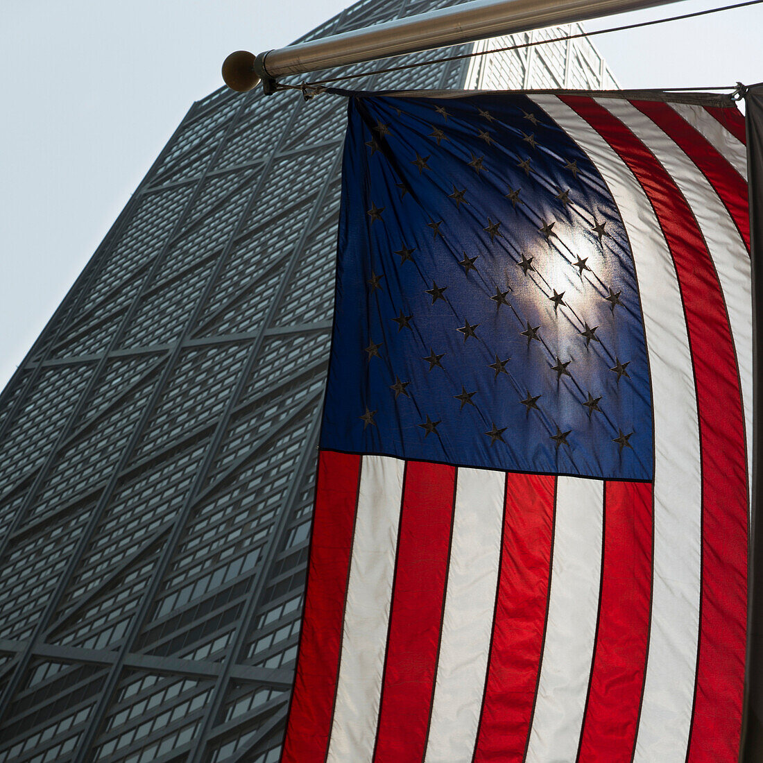 'American flag hanging with a building in the background;Chicago illinois united states of america'