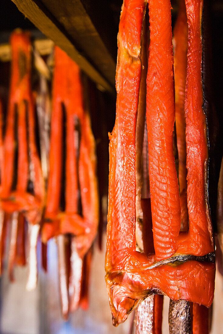 'Sockeye salmon from the kvichak river that has been stripped and hung to dry and smoke hang in a large smokehouse;Igiugig bristol bay alaska united states of america'