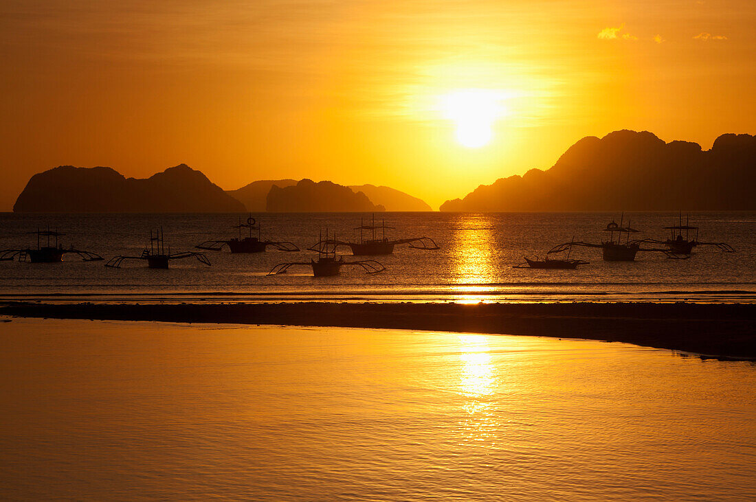 'Sunset View Of Islands And Boats From The Beaches Of Corong Corong Near El Nido; Bacuit Archipelago, Palawan, Philippines'
