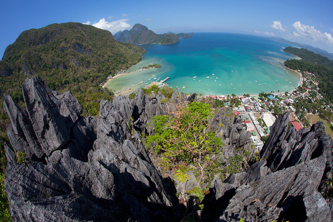 'An Aerial Fisheye View From The Top Of Sharp Limestone Spires Overlooking The Village Of El Nido; El Nido, Bacuit Archipelago, Palawan, Philippines'