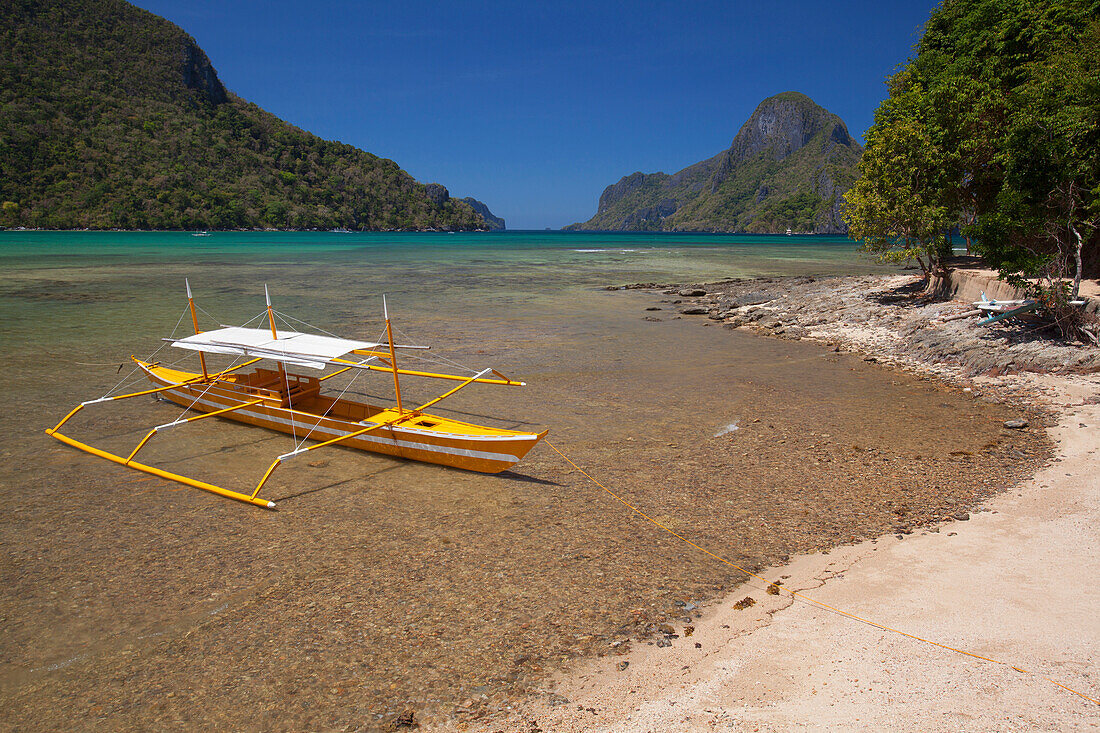 'A Tradional Wooden Bangka Boat Sits In The Picturesque And Scenic Bay; El Nido, Bacuit Archipelago, Palawan, Philippines'