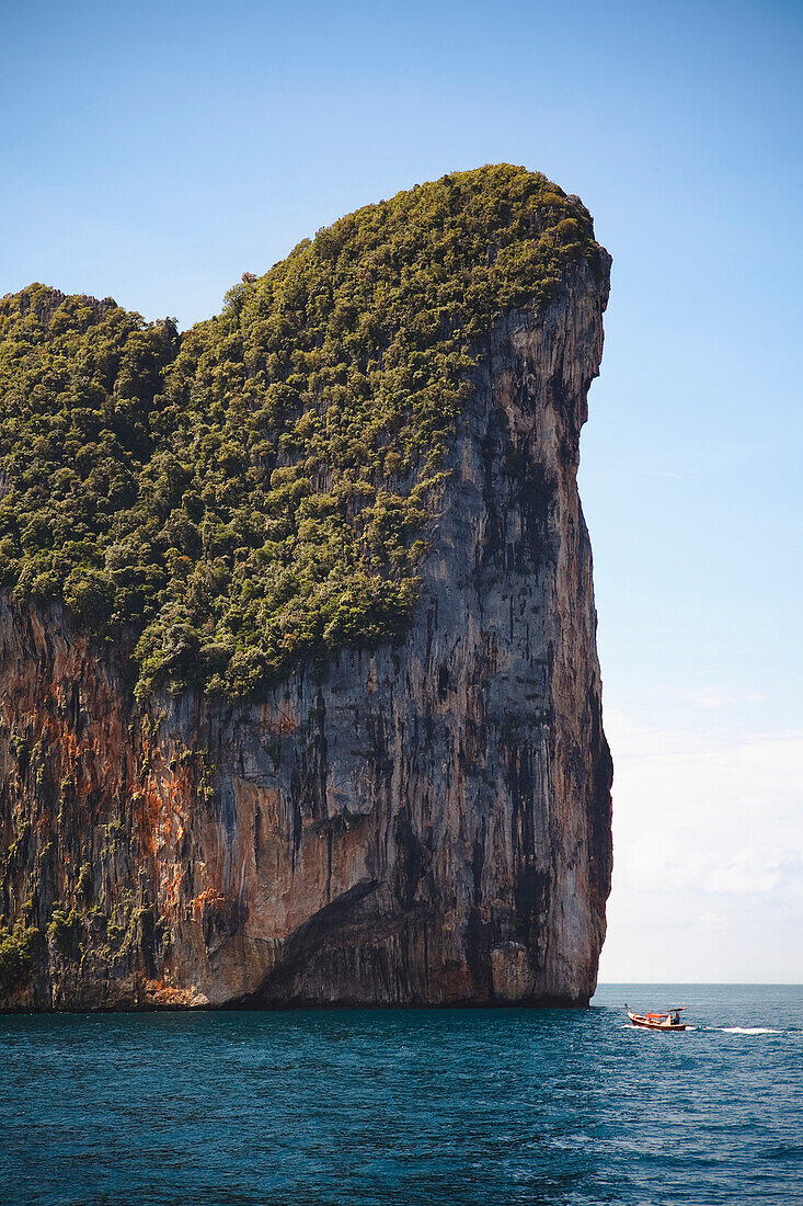 'A Boat Approaching One Of The Phi Phi Islands; Phuket, Thailand'