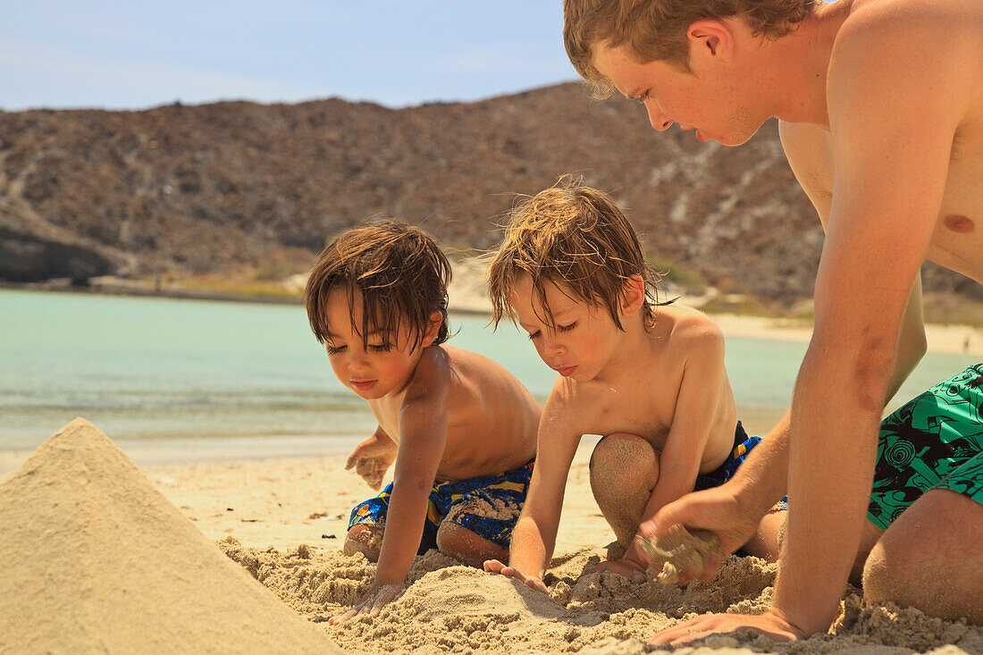 'Boys Playing In The Sand In Los Islotes National Marine Park On Espiritu Santo Island; La Paz, Baja, California, Sur Mexico'