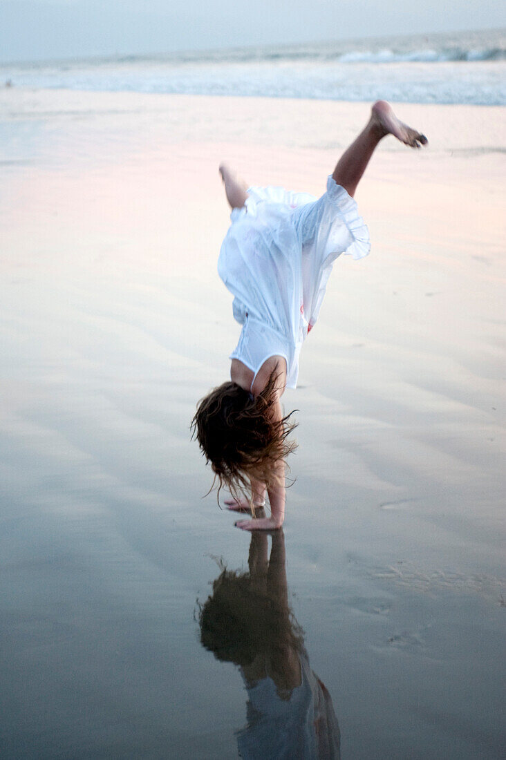 'Puerto Vallarta, Mexico; Girl Doing A Cartwheel On The Beach'