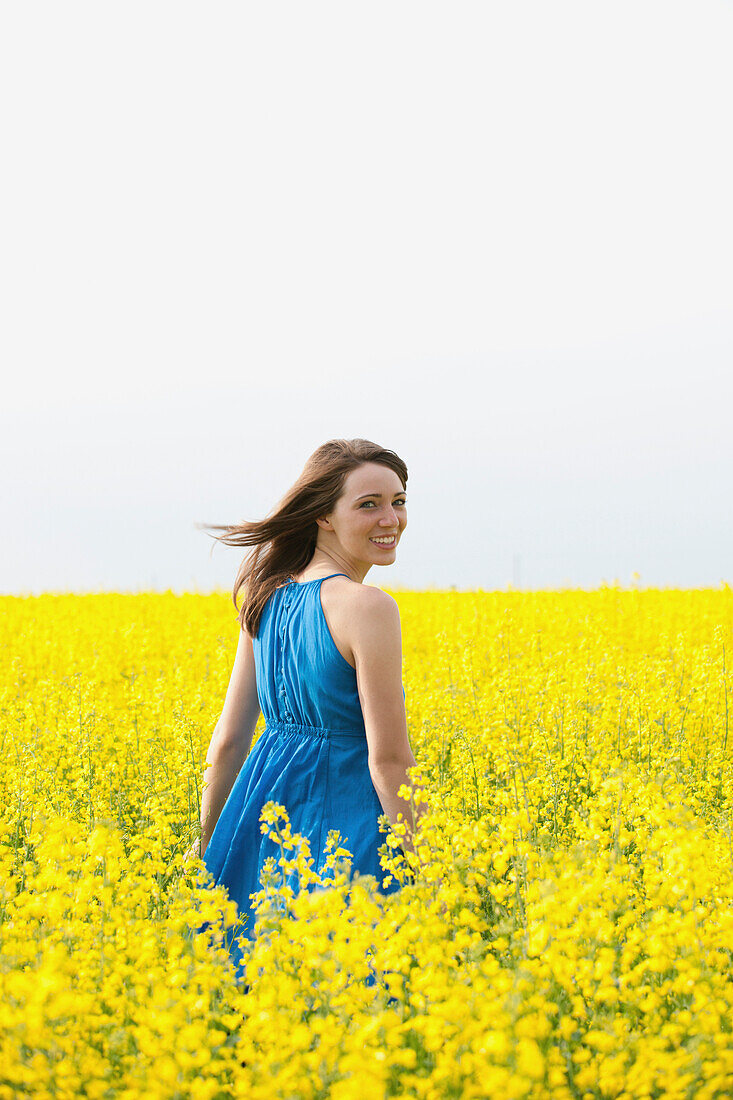 A Young Woman In A Canola Field