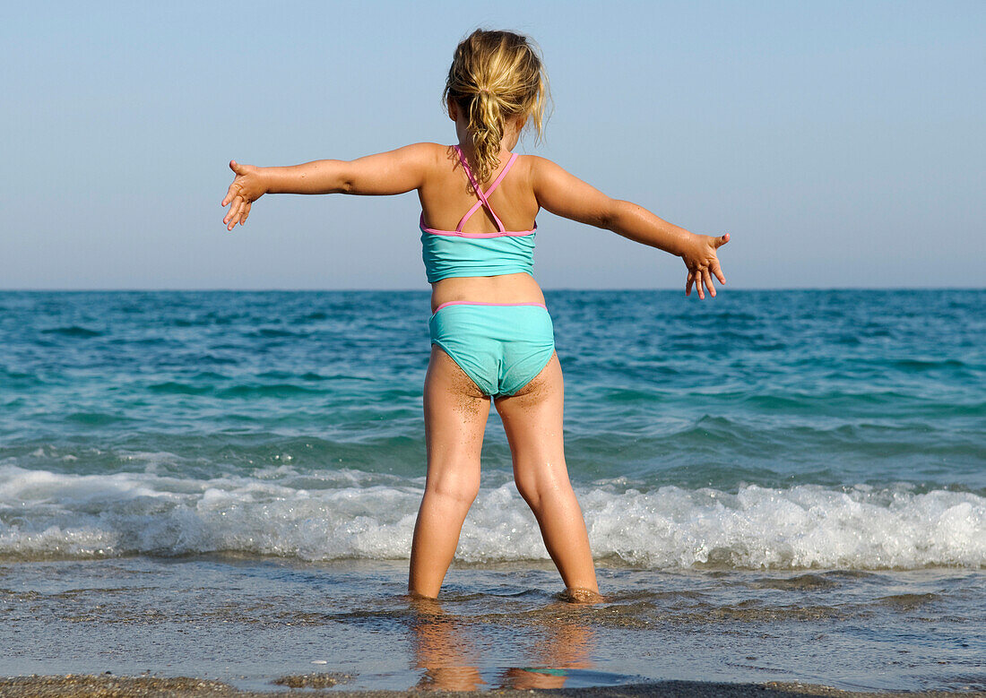 Girl Standing In The Waves