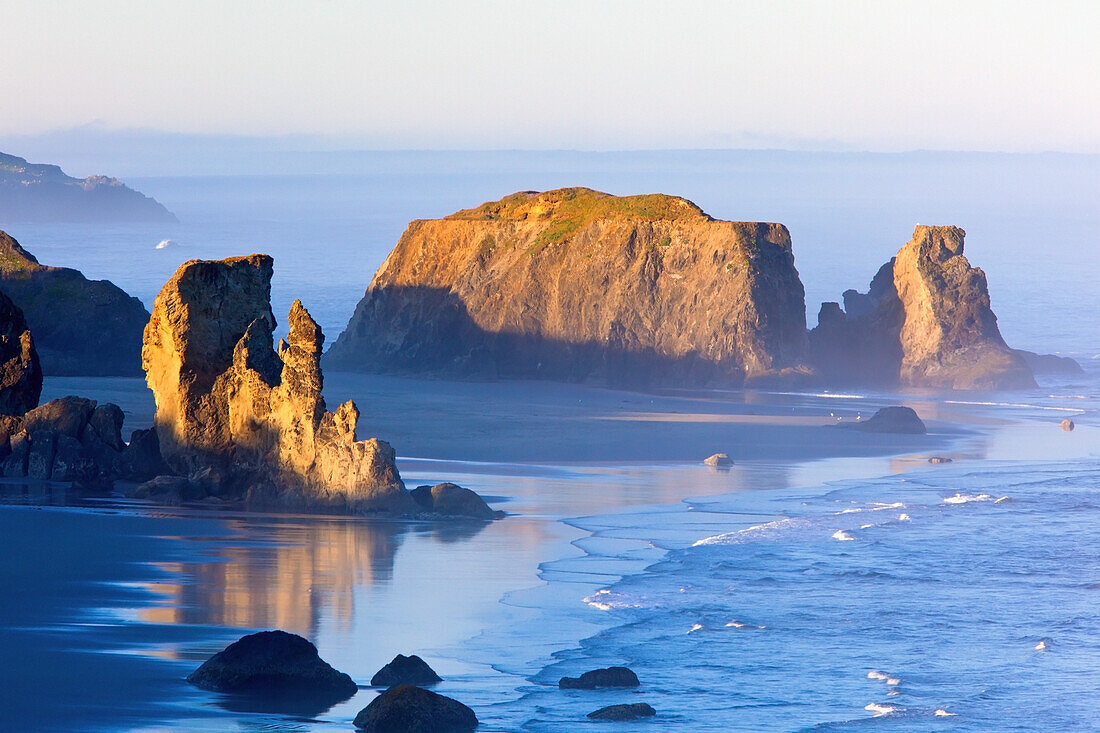 'Morning Light Adds Beauty To Fog Covered Rock Formations At Bandon State Park; Bandon, Oregon, United States of America'
