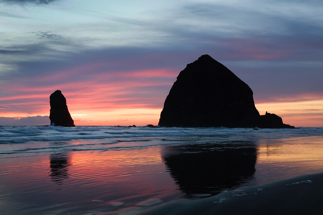 'Silhouette Of Rock Formations And Haystack Rock At Sunset; Cannon Beach, Oregon, United States of America'