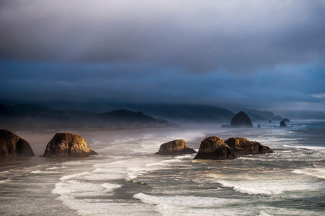 'Sunlight and mist create coastal moods; Cannon Beach, Oregon, United States of America'