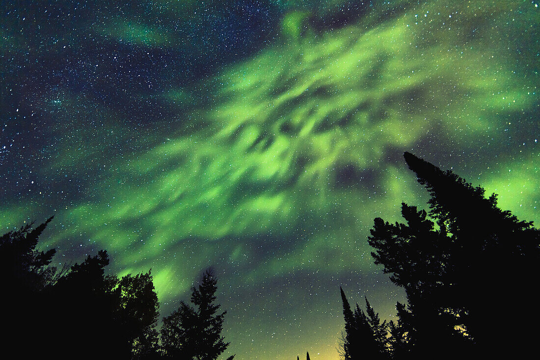 'Aurora Borealis and milky way visible in the sky, Mont-Tremblant National Park; Lanaudiere region, Quebec, Canada'