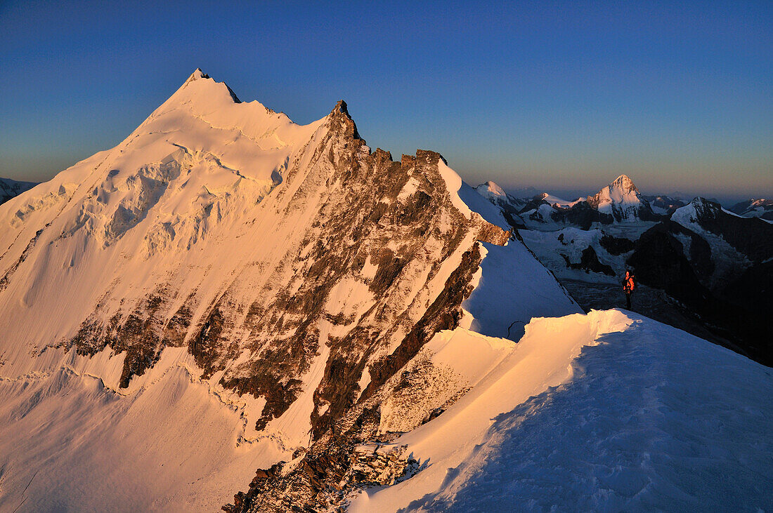 Mountaineer at Sunrise on the Bishorn: View into the northeastside of Weisshorn (4506 m), Wallis, Switzerland