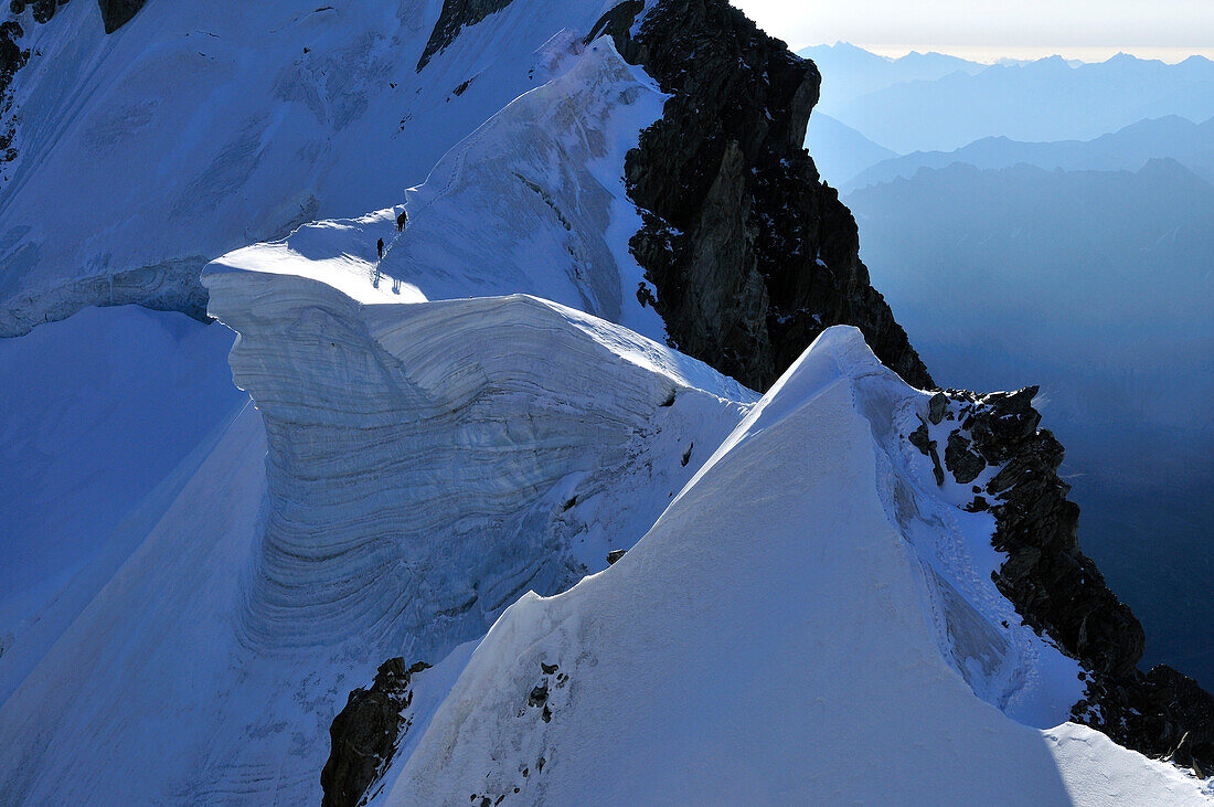 Mountaineers on a cornice at Arete Rochefort, Mont Blanc Group, France