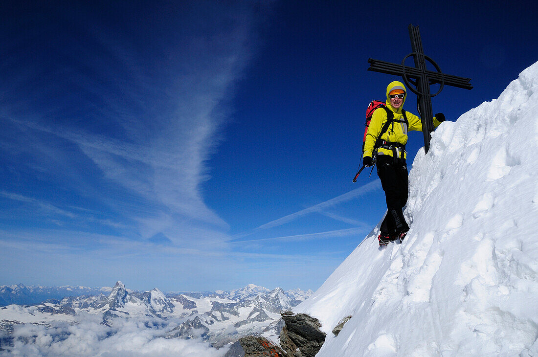 Climber at the summit of Täschhorn (4491 m), Matterhorn in the background, Wallis, Switzerland