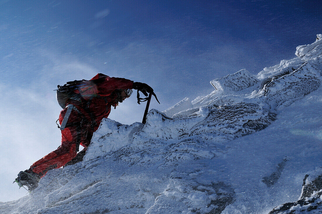 Mountaineer during snowstorm at Nadelhorn (4327 m), Wallis, Switzerland