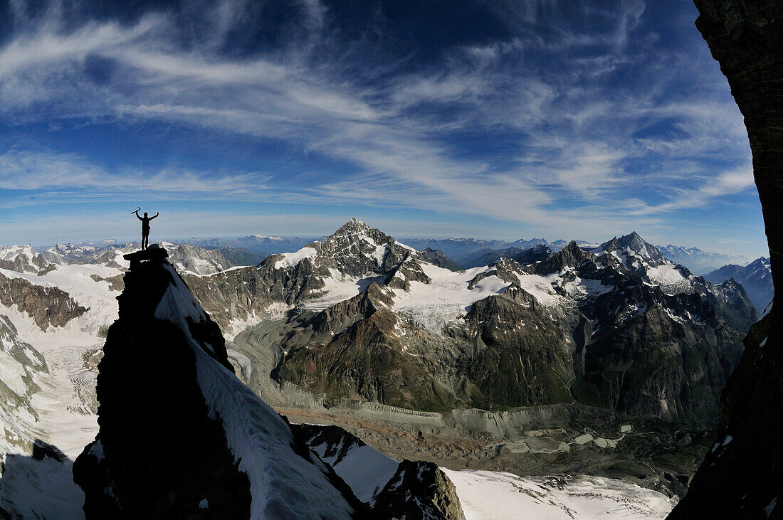Mountaineer at the Zmuttgrat (Northwest Ridge) of Matterhorn, Dent Blanche and Weisshorn in the background, Wallis, Switzerland