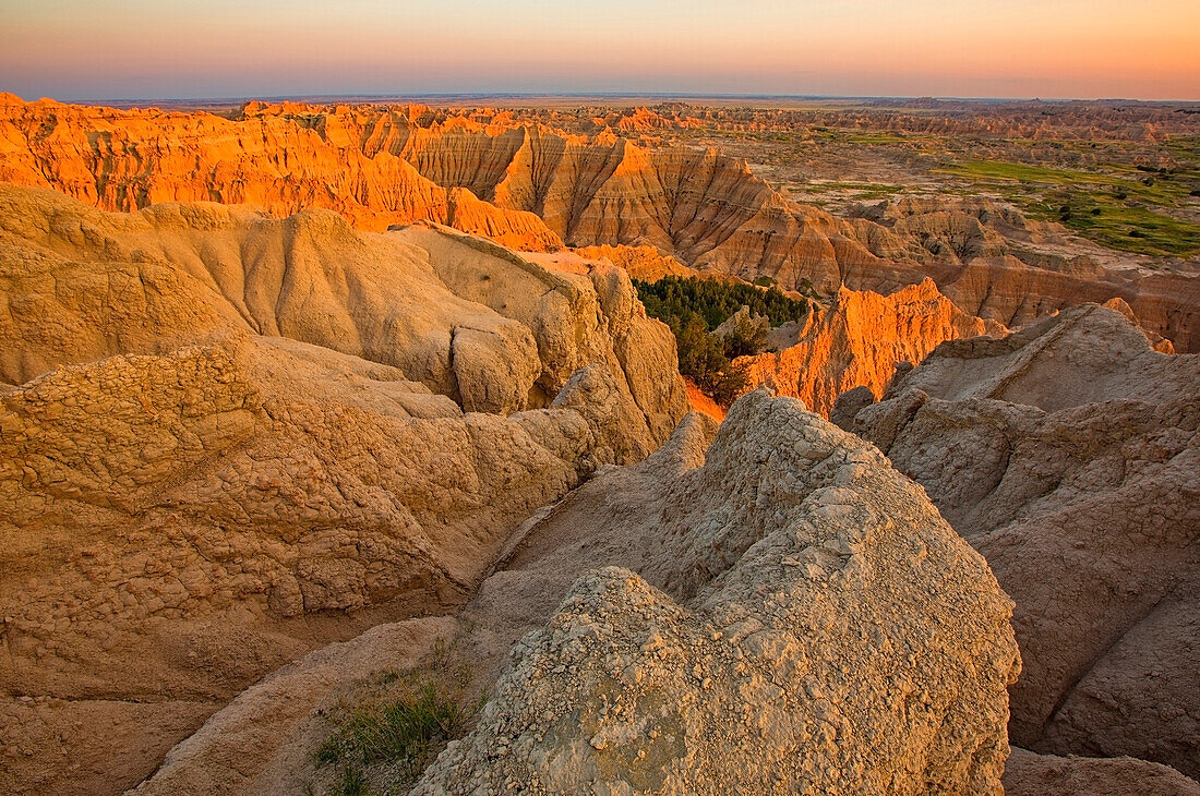 'The setting sun lights up the formations in badlands national park as seen from the pinnacles lookout; south dakota united states of america'