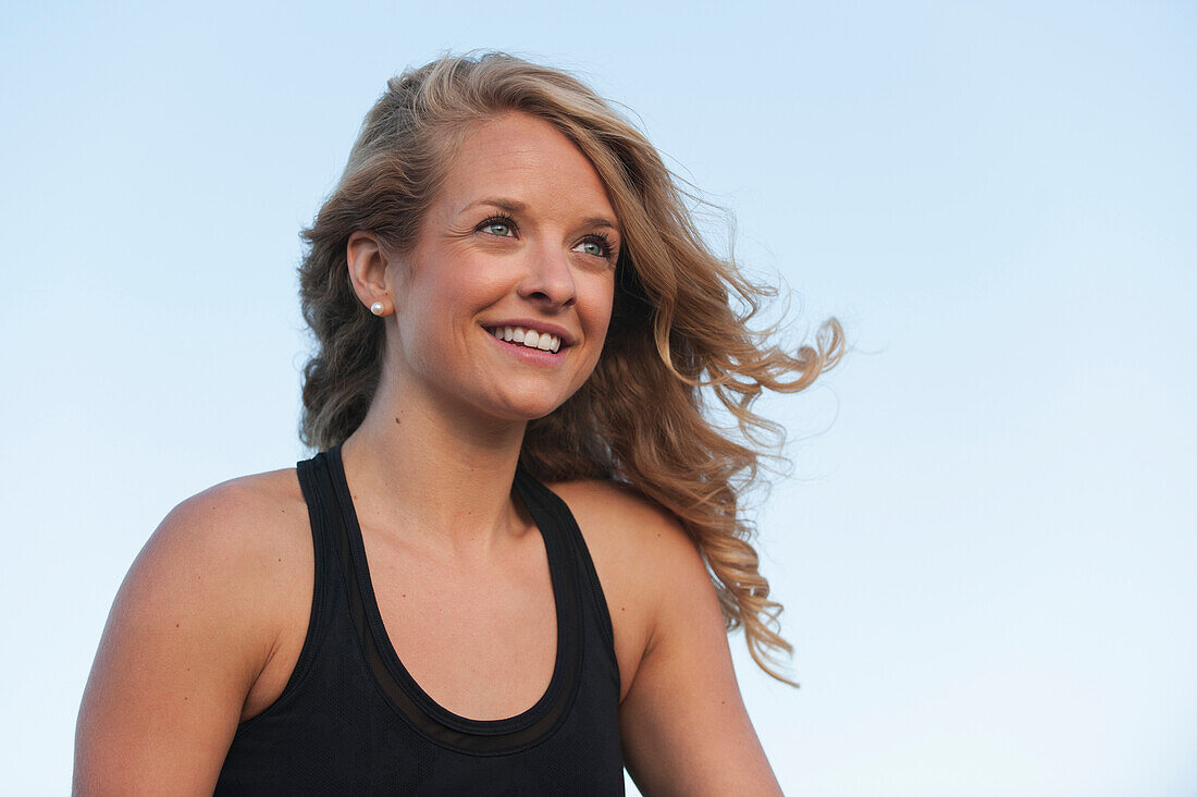 'Portrait of a woman with long blond hair against a blue sky;Arvada colorado united states of america'