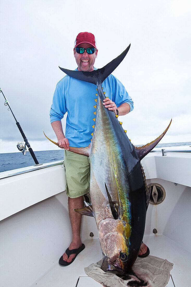 'Man holding a fresh caught yellowfin tuna; panama'